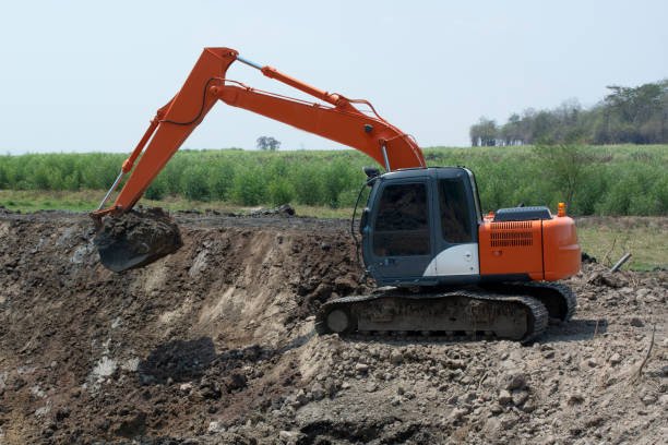 excavators are working to build ponds for agriculture in rural area.